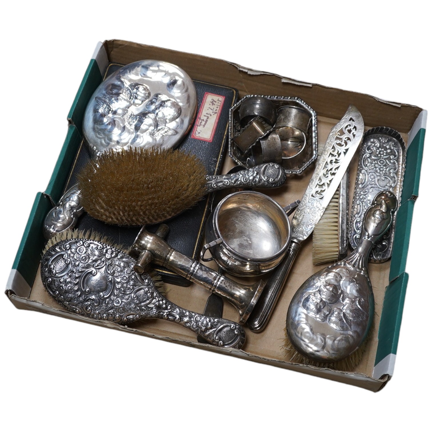 A mixed group of silver including mounted hand mirror, brushes, sugar bowl, napkin rings, bonbon dish, fish slice, part cased set of teaspoons, etc. Condition - poor to fair